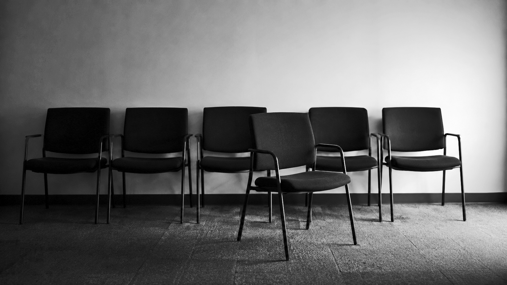 Empty waiting room chairs, representing regulatory scrutiny in wealth management
